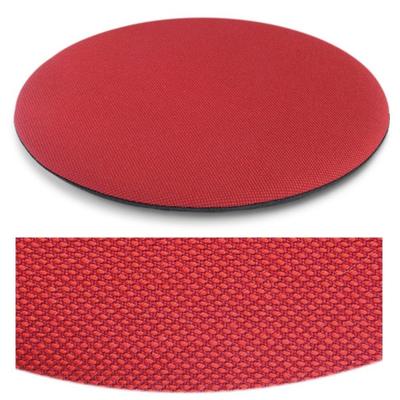 Das foto zeigt eine runde sitzauflage der firma discus. Die farbe der sitzauflage ist  rot meliert.