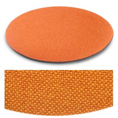 Das foto zeigt eine runde sitzauflage der firma discus. Die farbe der sitzauflage ist  orange-rot meliert meliert.