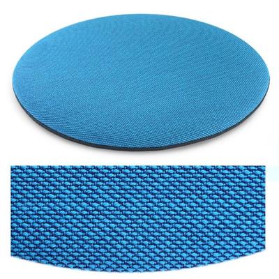 Das foto zeigt eine runde sitzauflage der firma discus. Die farbe der sitzauflage ist  türkis-blau meliert.