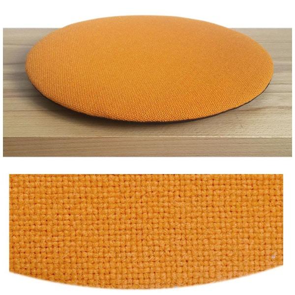 Das foto zeigt eine runde sitzauflage der firma discus. Das sitzkissen verjüngt sich zum rand hin und bildet eine schattenfuge aus. Die farbe der sitzauflage ist orange.